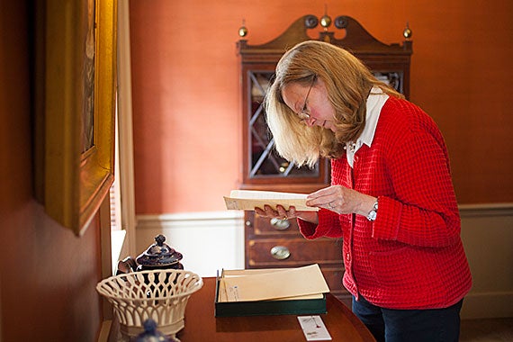 Houghton’s Leslie Morris, general editor of the Emily Dickinson Archive, studies a manuscript page.