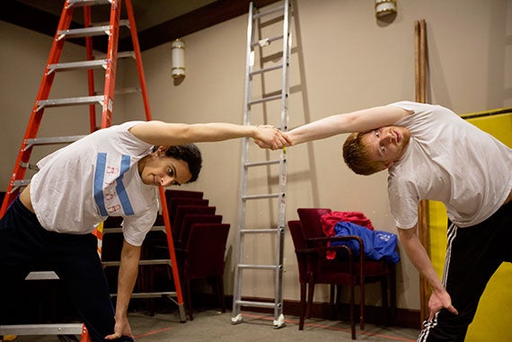 Ped Nasari (left) and Alec Wilson, both second-year graduate students from the A.R.T./MXAT Institute for Advanced Theater Training, stretch before rehearsal.