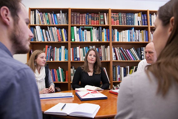 Students Natalia Gaerlan (clockwise, from right foreground), Trevor Johnson, Karina Gilbert, and Kristen Hunter brief team faculty adviser Jerold Kayden three days after returning from Japan. Photo by Melanie Rieders