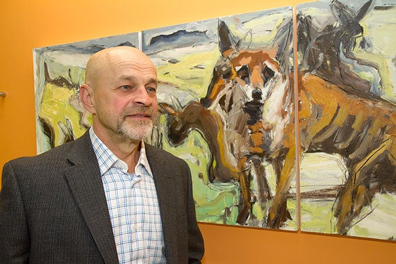 Artist Gedas Paskauskas posed next to his painting during the opening of the exhibit at the Ed Portal.