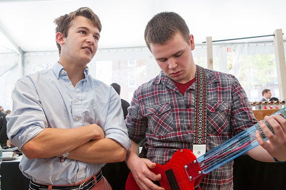 Ian Meyer '17 (left) listens as Neal Champagne '17 plays an unusual electric guitar.