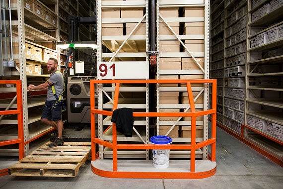 Pickers use neon yellow harnesses to secure themselves to the lifts, which extend to the tops of the shelves, over five times the height of the average American man.  “A lot of us aren’t afraid of falling, but we don’t ever have to worry about that, it’s completely safe,” said Keith Lyseth, an operations specialist.