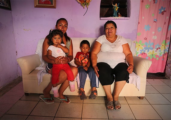 Maria Dolores León Torres (left), at home with her family in the La Vista neighborhood of Chapala, Mexico. She and her son Juan de Dios, age 4 (center), were part of a Harvard study investigating suspected contamination in fish from Lake Chapala. “We haven’t ever gotten ill,” she said. Photos by Ned Brown/Harvard Staff