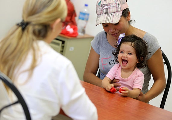 In a health clinic in Jocotepec, Mexico, 11-month-old Genesis laughs at the sound of plastic blocks — part of a test series called the Bayley Scales of Infant Development used to assess language, cognition, and motor skills in children to age 3. In the Harvard study, 167 such tests were done.