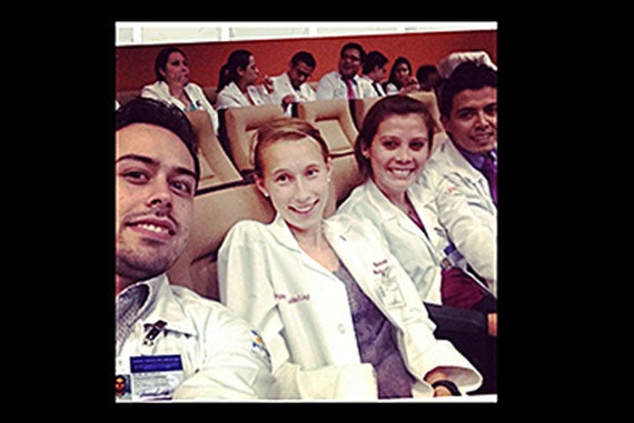 Harper Hubbeling (center), a second-year student at Harvard Medical School, sits with young colleagues during her research summer at Mexico's largest cancer hospital. Photo courtesy of Harber Hubbeling