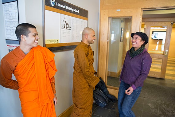 Harvard Divinity School students Priya Rakkhit Sraman (from left), a Buddhist monk from Bangladesh, and Bhante Kusala, from Sri Lanka, share a laugh with fellow student Katrina Peterson. 