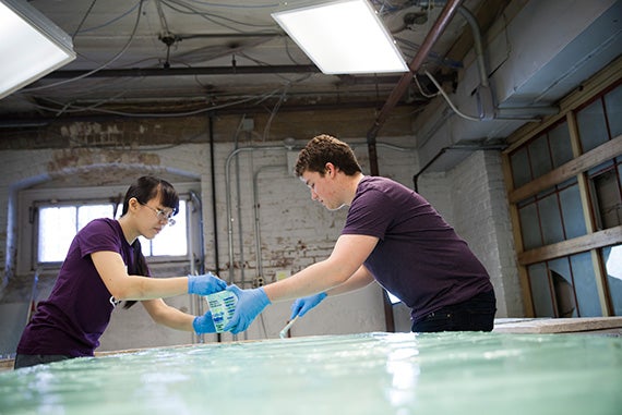Rebecca Chen ’16 (left) and Noah Wuerfel ’17 carefully apply a thin layer of silicone. 