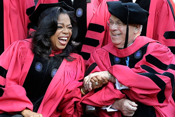 Oprah Winfrey clasps Boston Mayor Thomas Menino’s hand. Both received honorary degrees in 2013. Photo by Elise Amendola/AP Photo