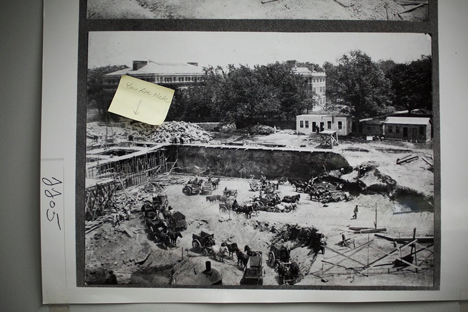 A 1913 photo of the Widener excavation, with a “You Are Here” sticker in the corner, hangs in Digital Imaging and Photography Services.