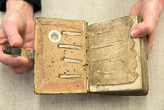 The inside of this small book of English statutes, circa 1300, reveals the intricate original binding.
