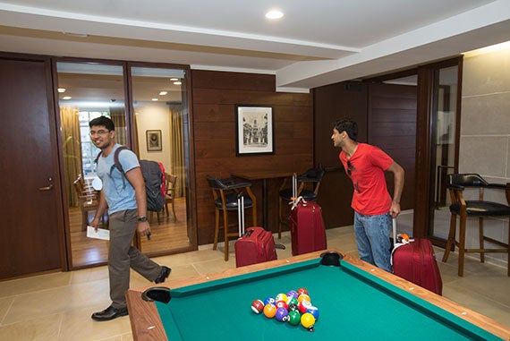 A pool table marks one of the lounge areas that Idrees Kahlon '16 (left) and Vivek Banerjee '16 pass through on the way to their room.