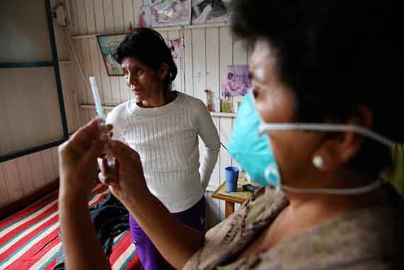 Community health worker Bertha Huaman prepares an injection of capreomycin, a drug used to treat XDR-TB, as part of the program to provide aid to patients in their homes. Photos by Alonso Chero