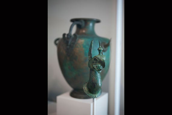 View of “Griffin Protome from a Cauldron,” c. 620-590 BCE, in front of “Hydria (water jar) with Siren Attachment,” c. 430-400 BCE, from the collection of the Arthur M. Sackler Museum. Stephanie Mitchell/Harvard Staff Photographer