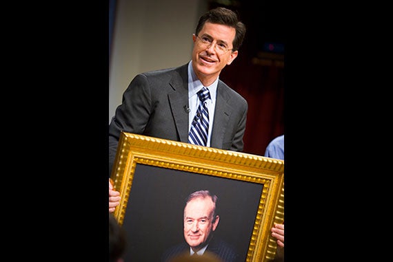 Stephen Colbert, host of "The Colbert Report" on Comedy Central, holds a portrait of radio talk show host Bill O'Reilly at the Harvard Kennedy School, Dec. 1, 2006. Photo by Justin Ide