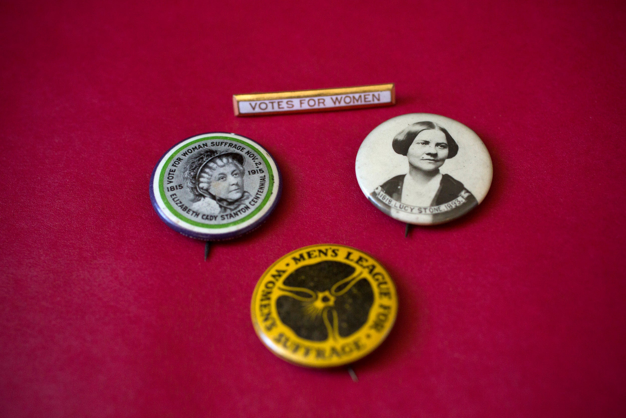 Women’s suffrage buttons show the likenesses of early suffragists Elizabeth Cady Stanton and Lucy Stone.