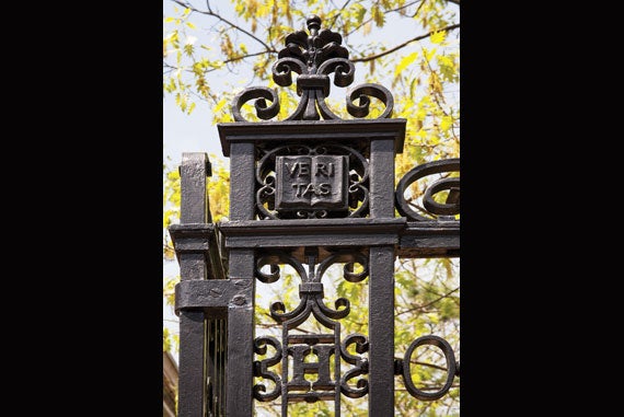 The Harvard H and a single book displaying Harvard’s “Veritas” motto adorn one side of Robinson Gate. Image credit: Ralph Lieberman