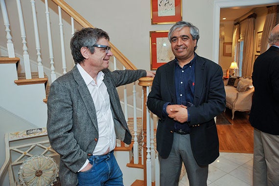 Andrew Strominger (left), the Gwill E. York Professor of Physics, chats with Subir Sachdev, the Herchel Smith Professor of Physics, before a dinner at the home of Donner Professor of Science Cumrun Vafa in honor of Stephen Hawking's visit to Harvard. Photos by Jon Chase/Harvard Staff Photographer