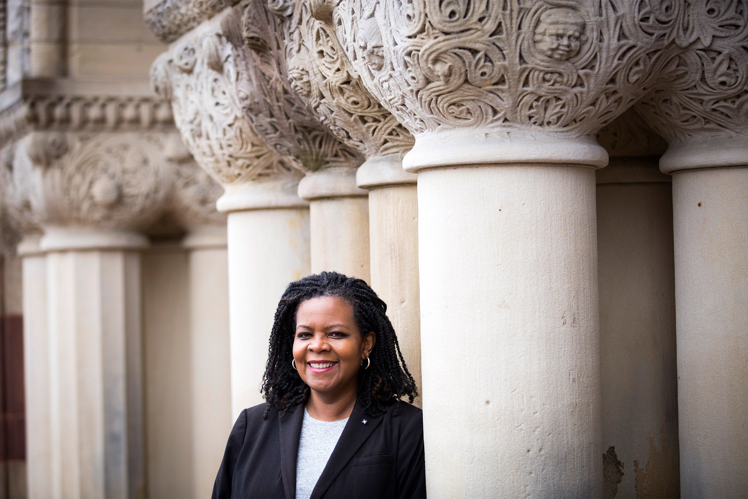 Annette Gordon-Reed standing by columns.