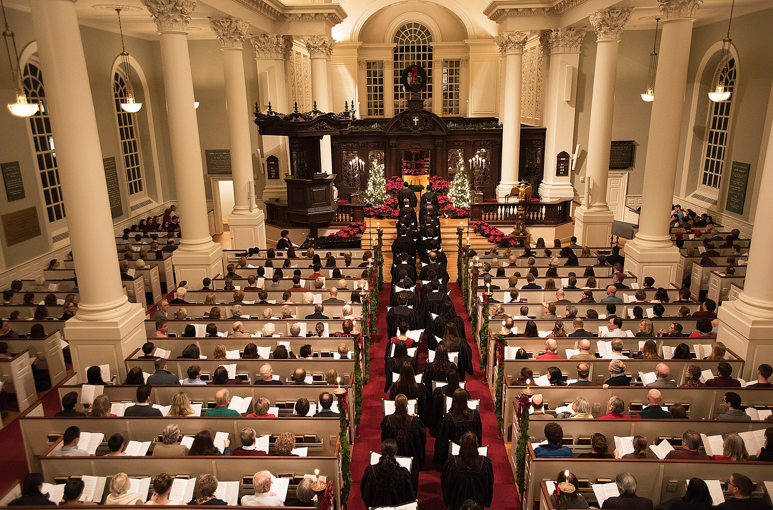 Harvard choir marches through sanctuary.