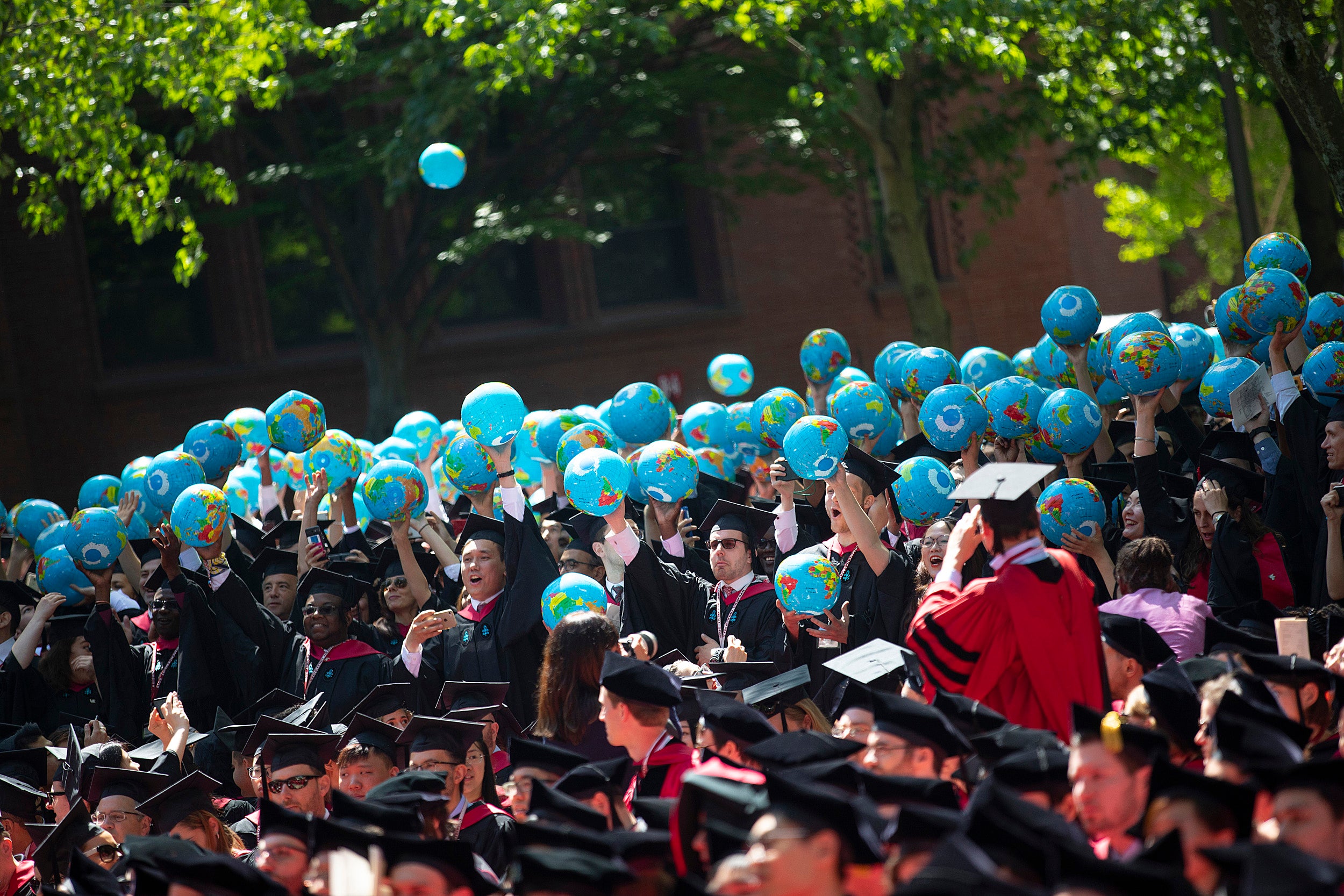 Graduates let inflatable globes loose.