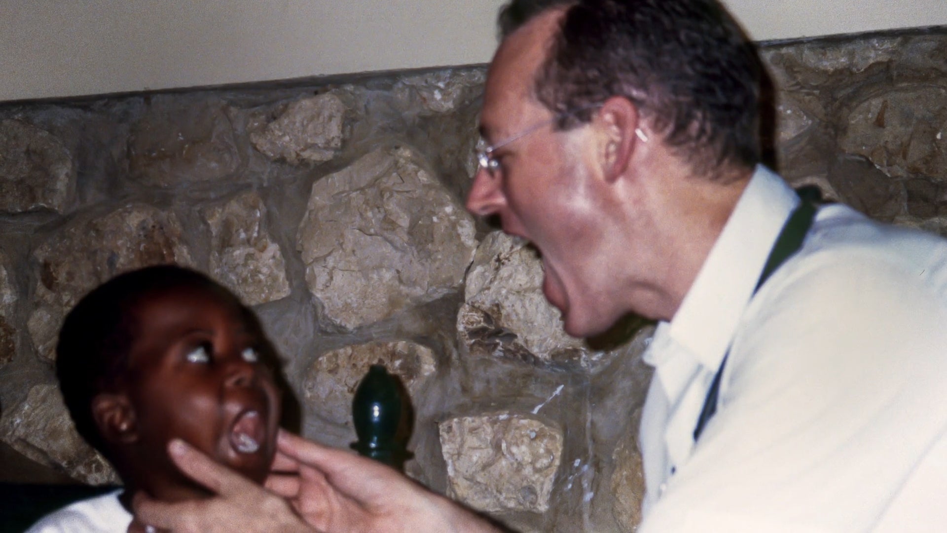 Dr. Paul Farmer examines a young patient in Haiti.