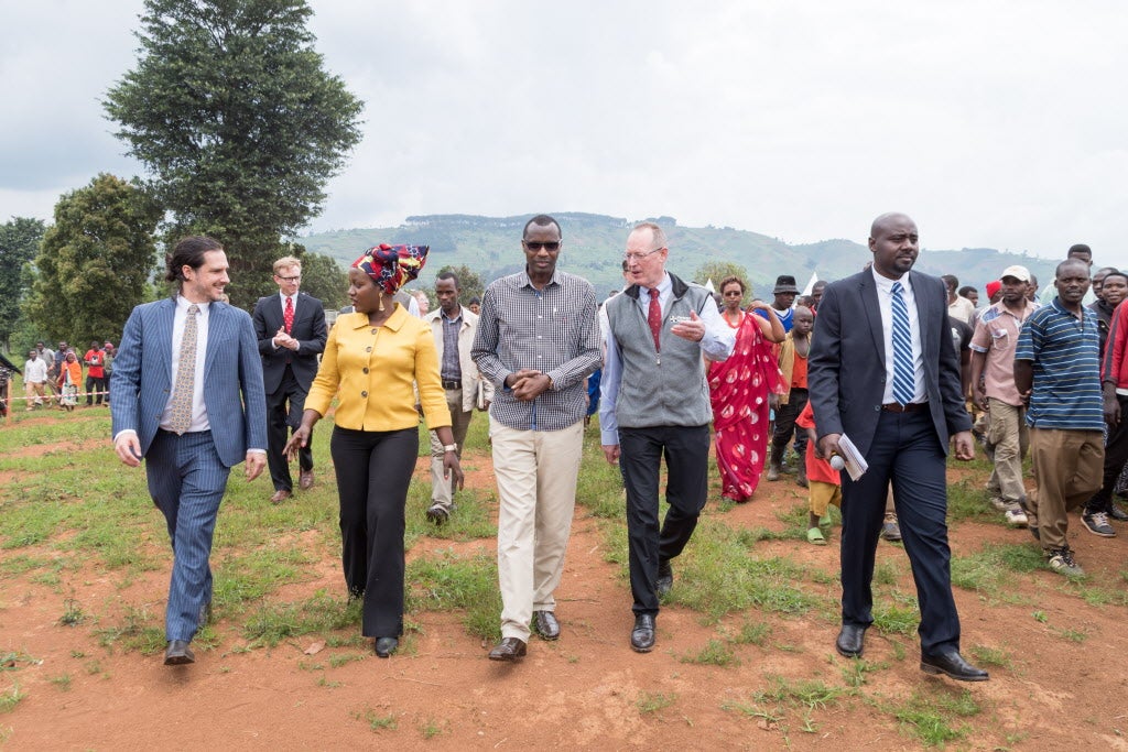 Peter Drobac, Antoinette Habinshuti, Musafiri Papias Malimba, Paul Farmer, and Emmanuel Kamanzi walk the grounds of the future University of Global Health Equity in Rwanda.