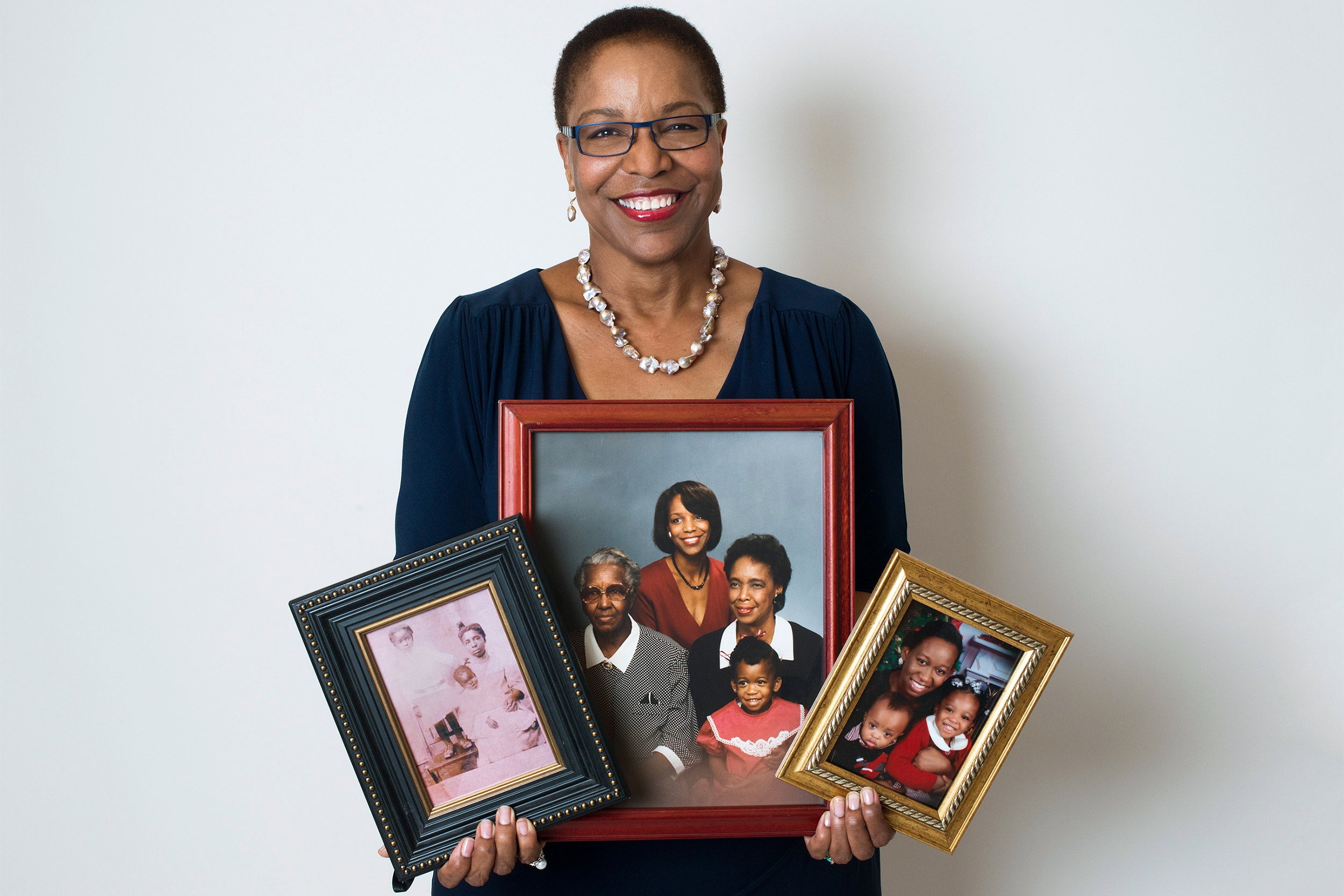 Joan Reede with photos of her family.