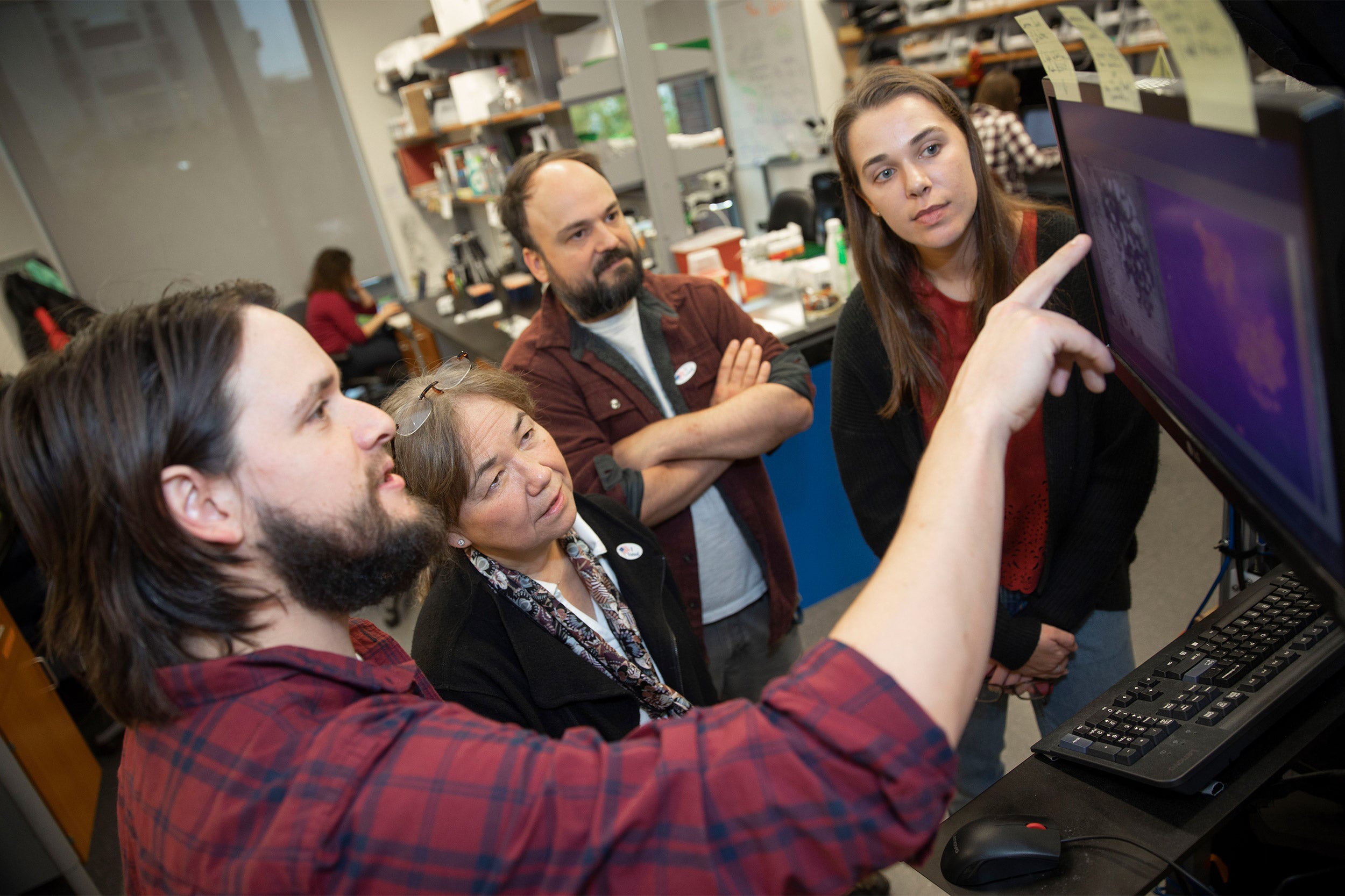 James Crall (from left) is the lead author of a new study that shows a particular class of pesticides can have dramatic effects on bees inside Northwest Labs. He is seen with co-authors, Naomi Pierce, Ben de Bivort, Andrea Brown '19.