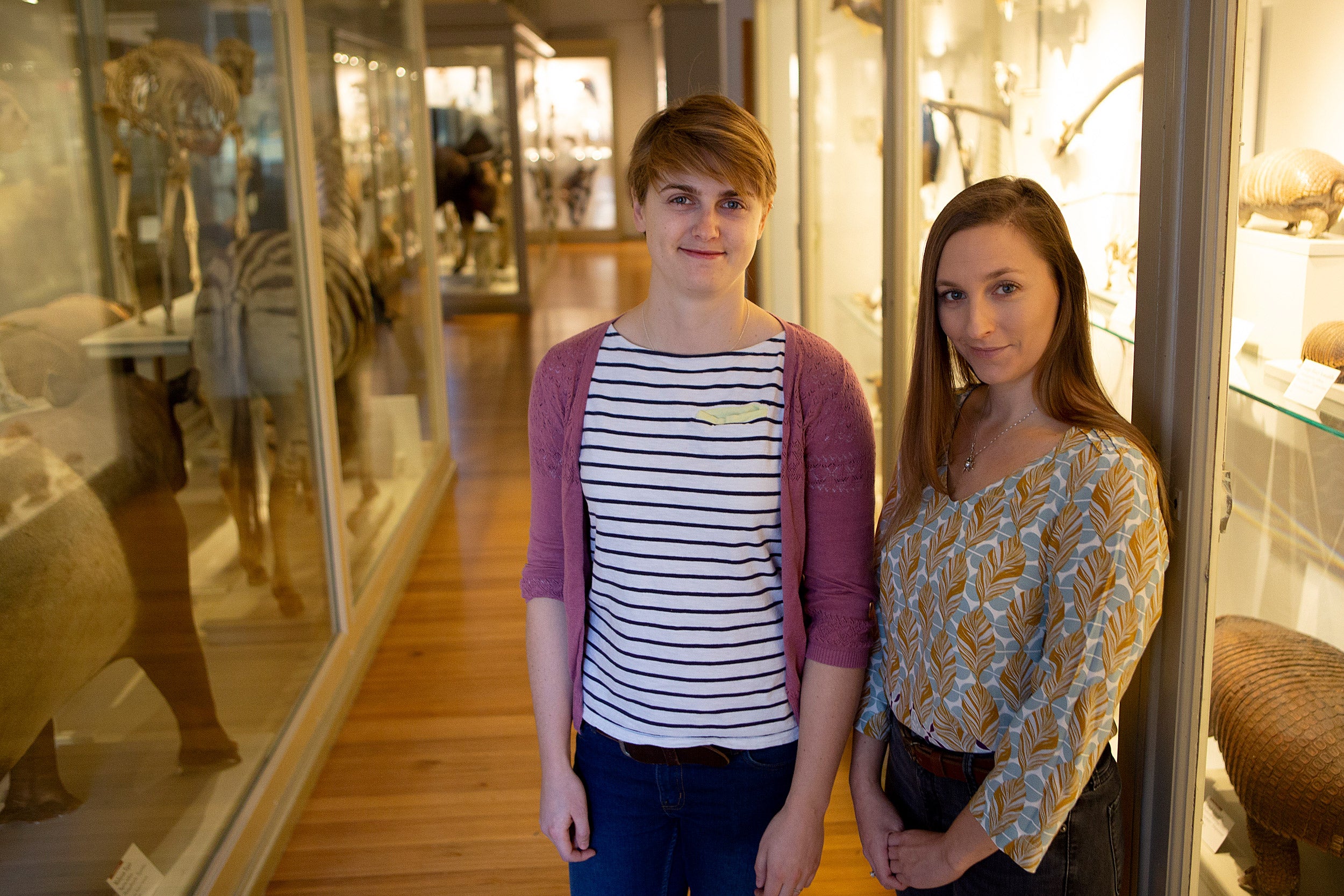 Sophie Regnault and Stephanie Pierce stand in front of Harvard Natural History Museum exhibits.