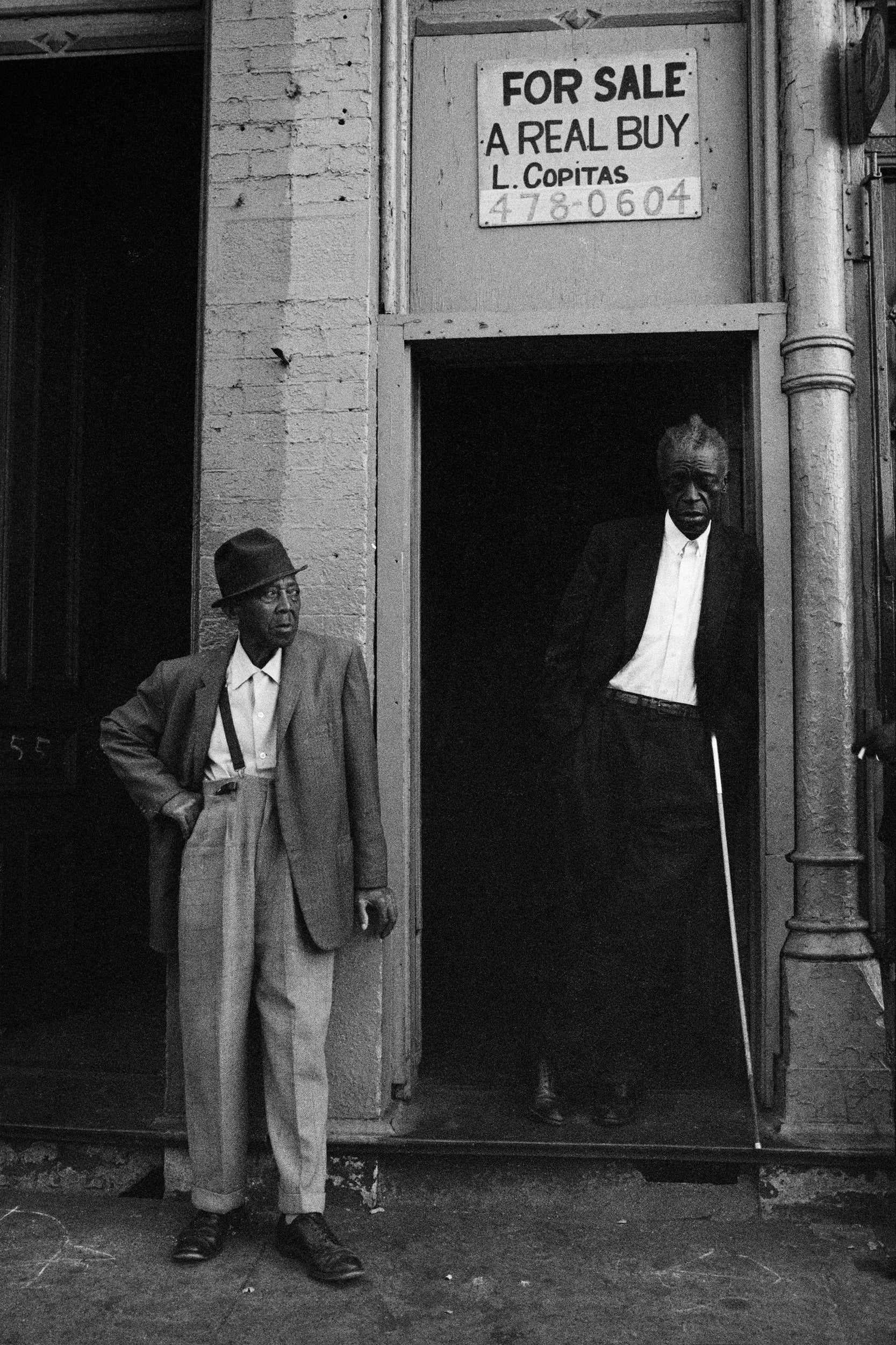 Two men stand in front of building with For Sale sign in Chicago in 1966.