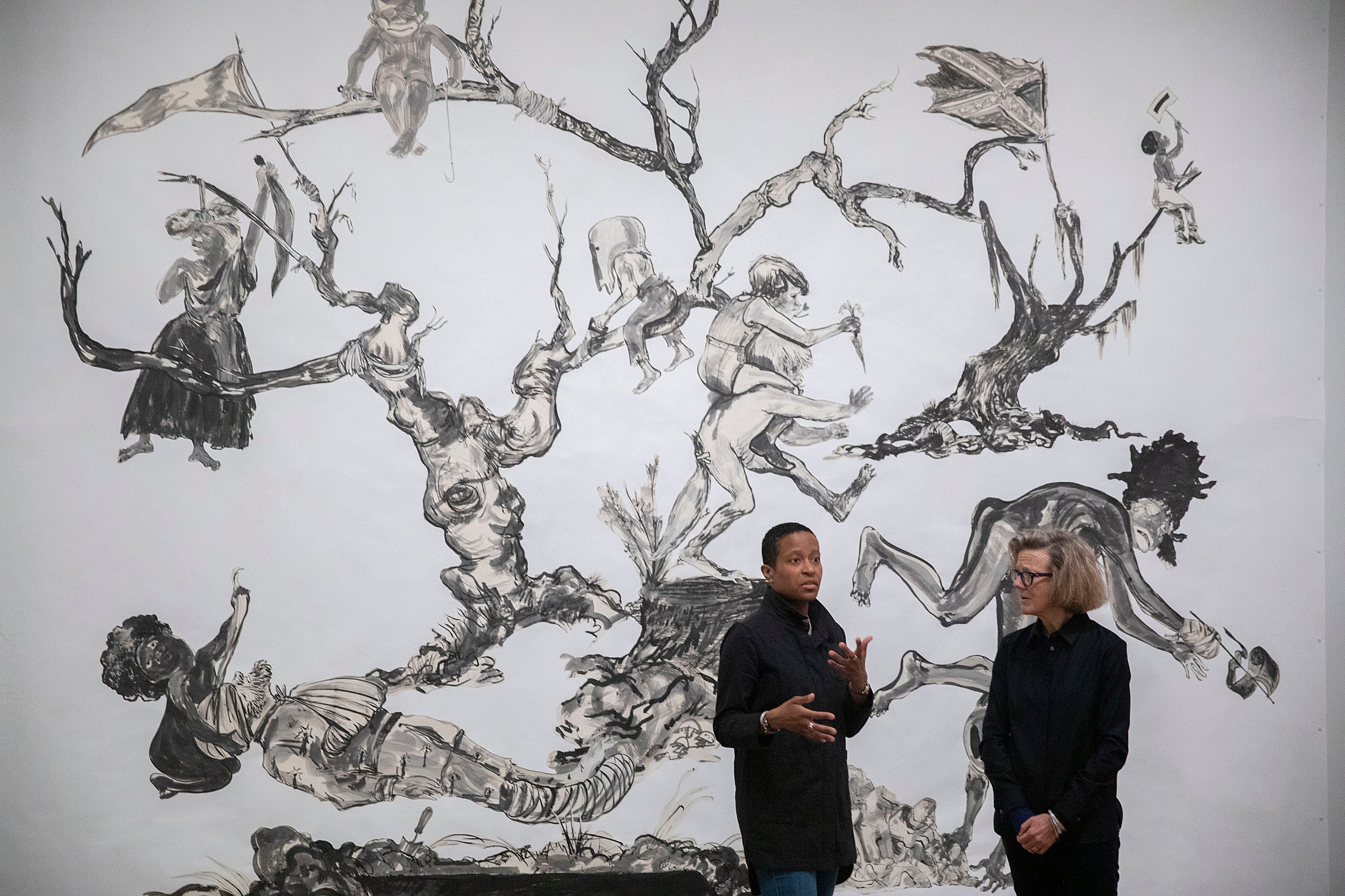 Chassidy Winestock and Mary Schneider Enriquez with Kara Walker's art U.S.A Idioms..