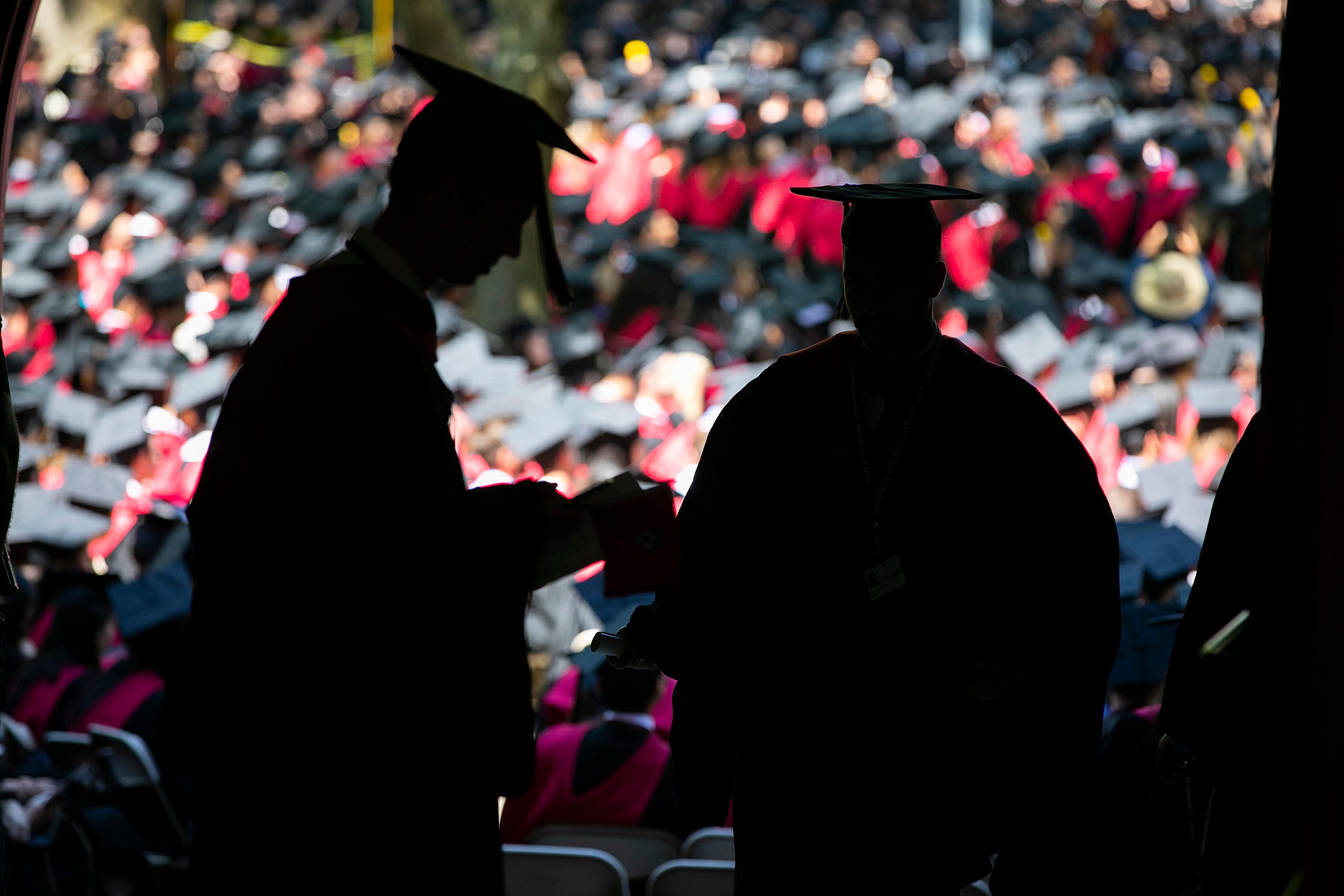 Graduates in silhouette.