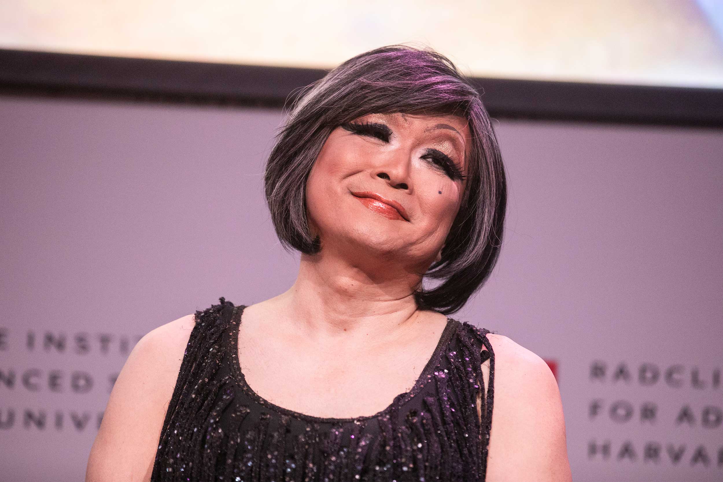 Shigehisa Kuriyama, Faculty Director of the Humanities Program, Radcliffe Institute, takes a bow after being given a gender makeover on stage.