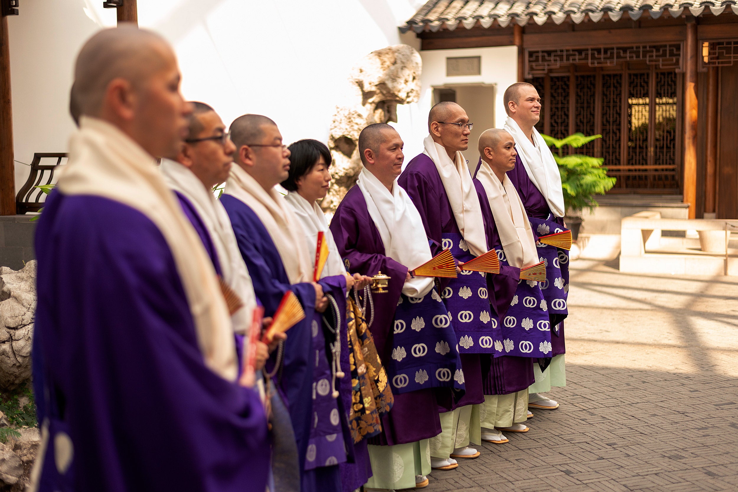 Buddhist priests stand in line during a ceremony