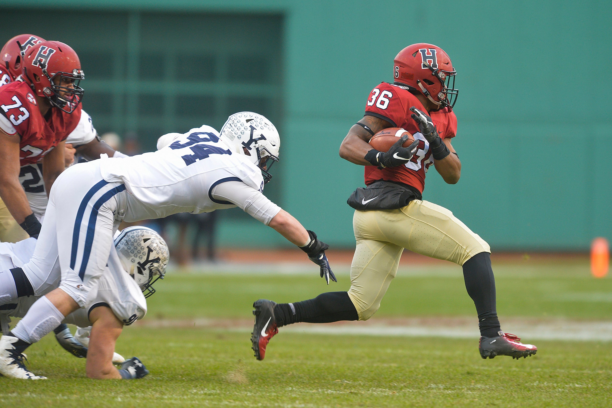 A Harvard football player running down the field