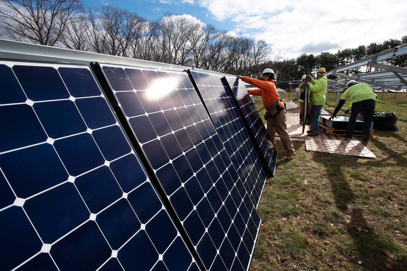 Construction workers erect solar panels