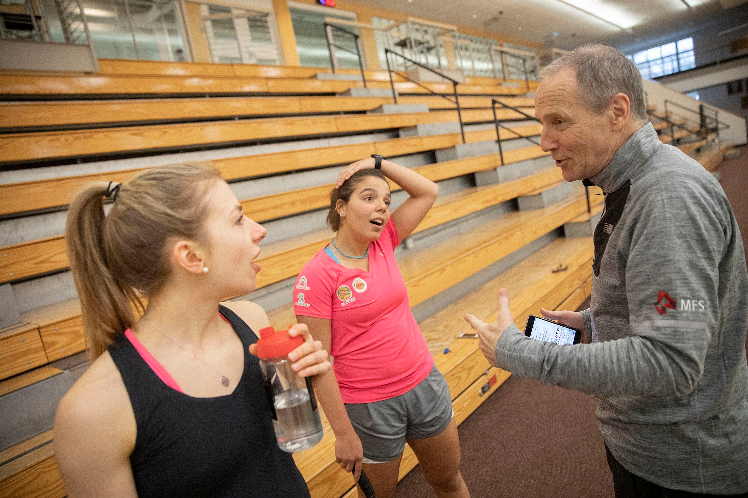 Amelia Henley and Amina Yousrytalk to coach Mike Way at the Murr Center.