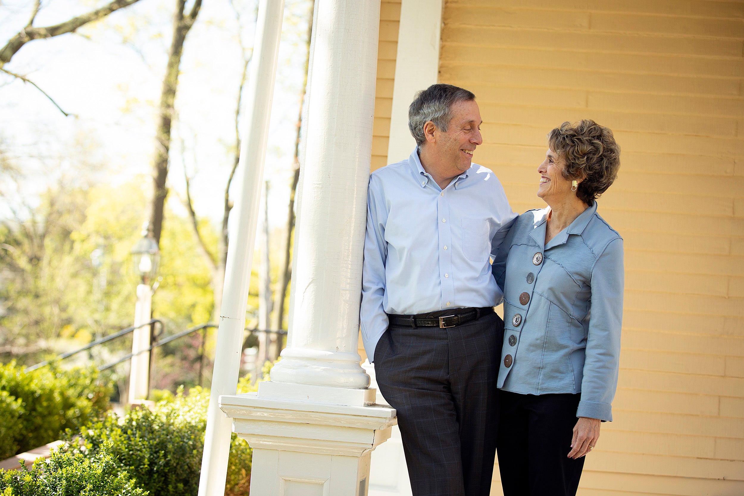 Larry and Adele Bacow standing on their porch of their Elmwood home.
