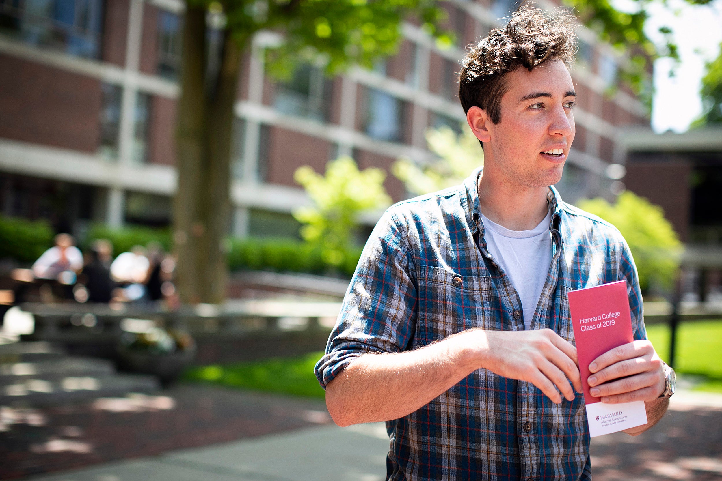 Jacob Link holds a Commencement brochure