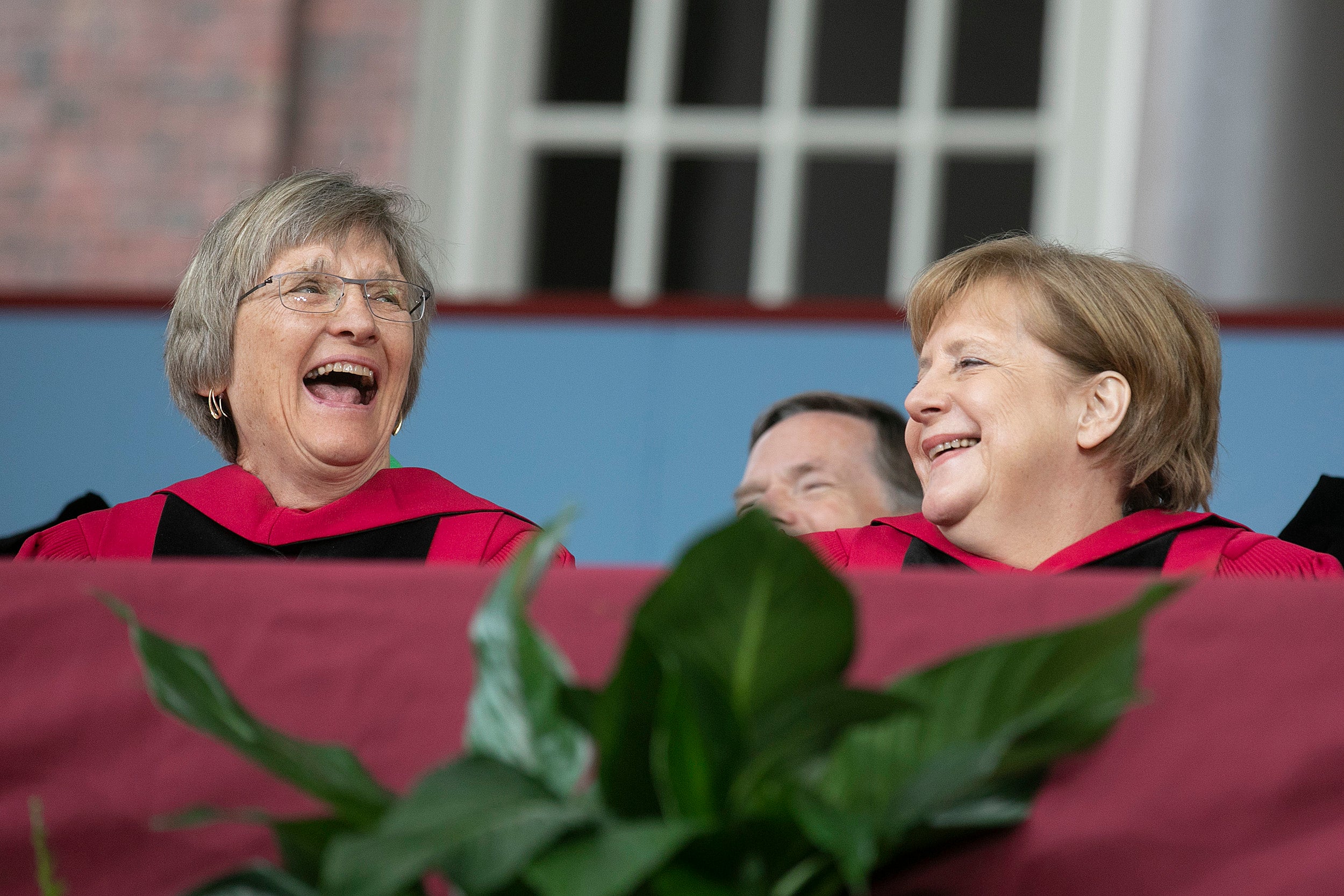 Drew Faust laughs with Angela Merkel