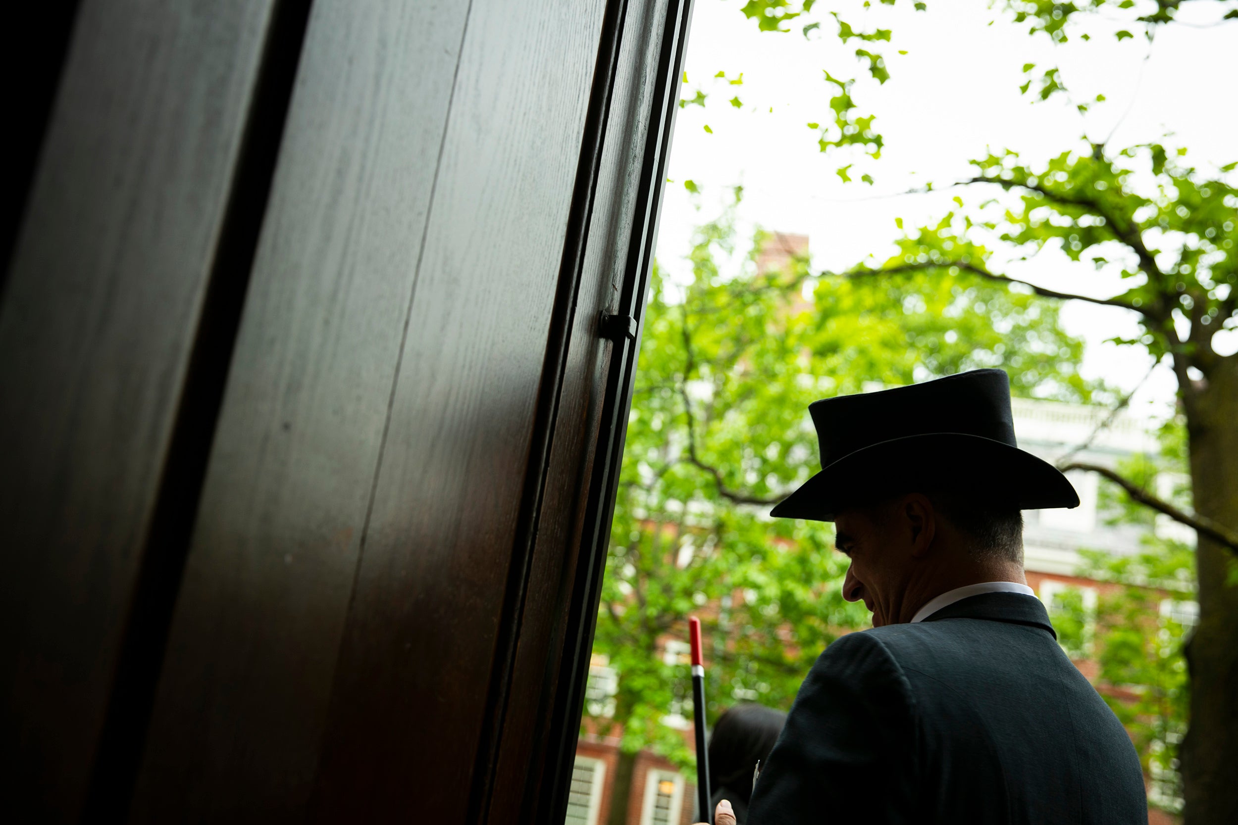 Jonathan Sapers wears a fancy hat outside Harvard Hall.