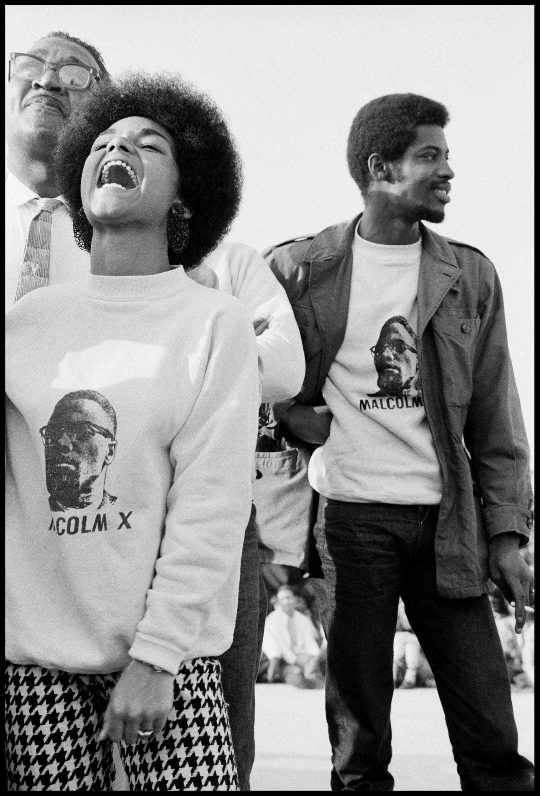 Three people wearing Malcolm X shirts