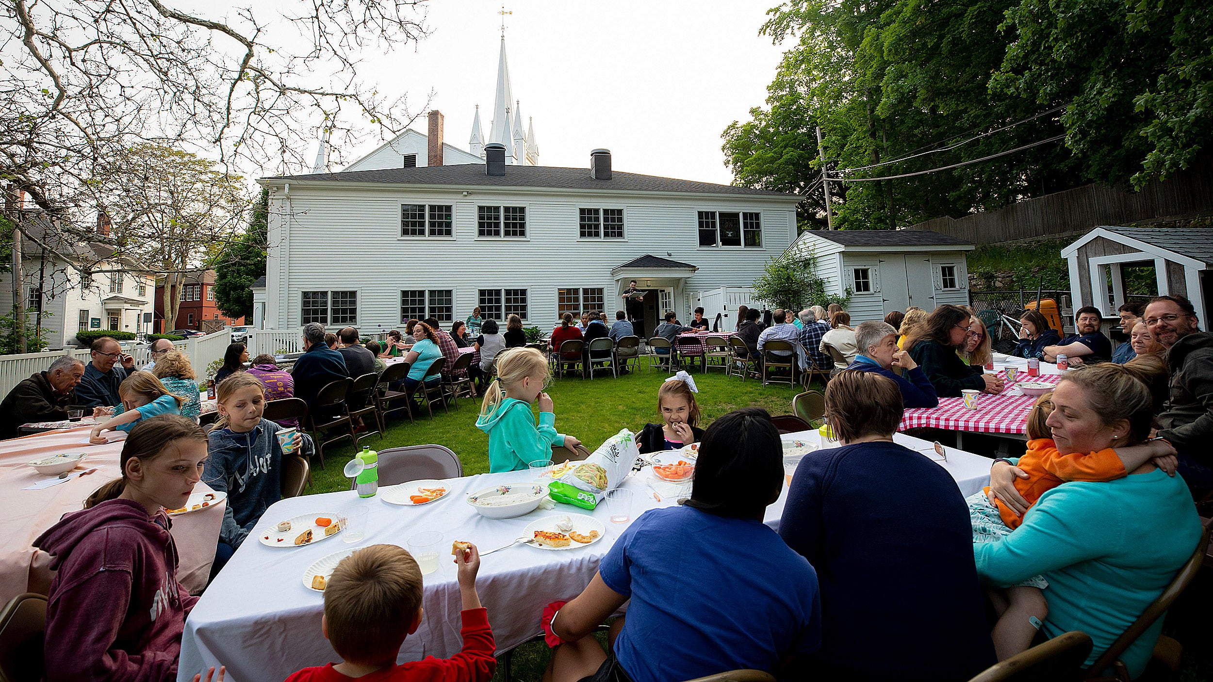 The congregation of North Andover Unitarian Universalist holds a "Sacred Supper" outside the church.