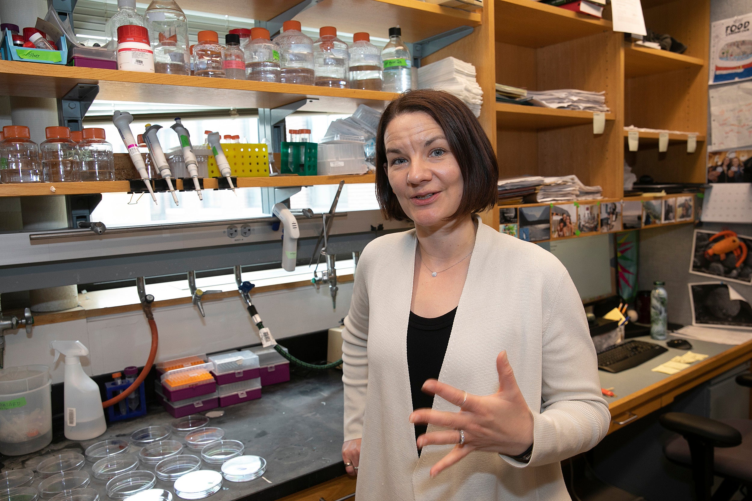 Professor Emily Balskus explains a scientific process in the lab