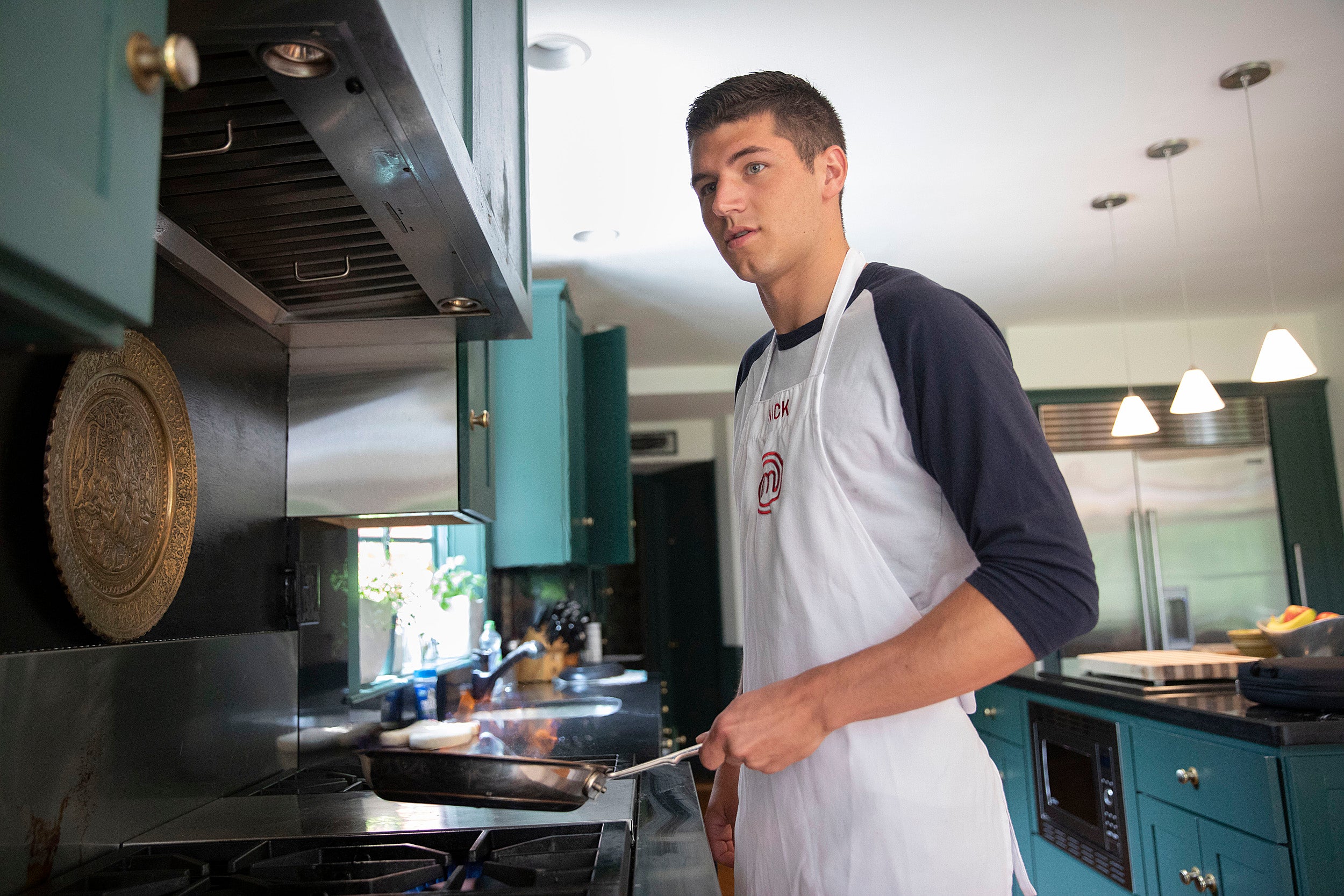 Nick DiGiovanni cooks at his home in Milton.