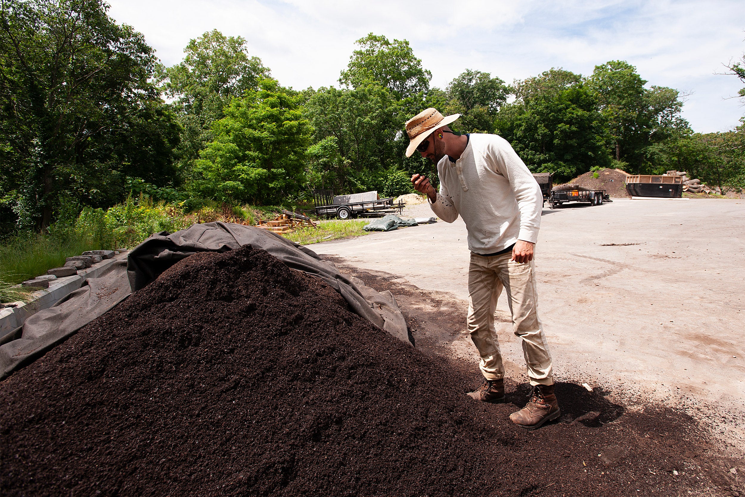 Man examines compost pile