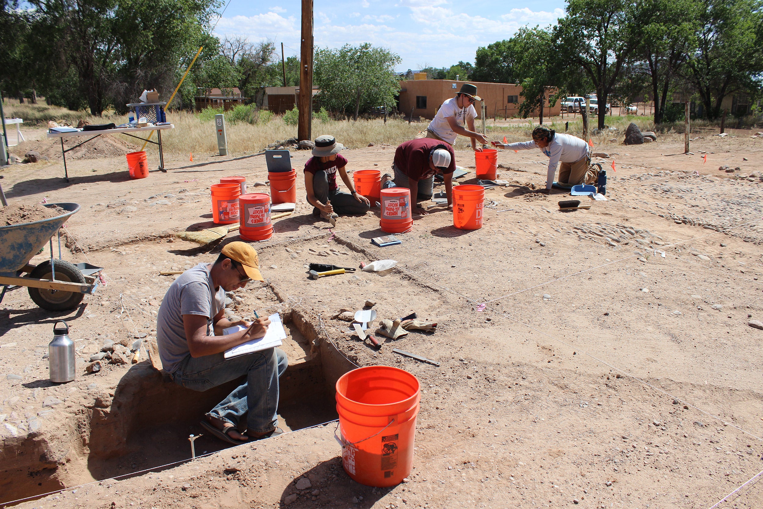 Harvard students and tribal members working at archaelogical dig