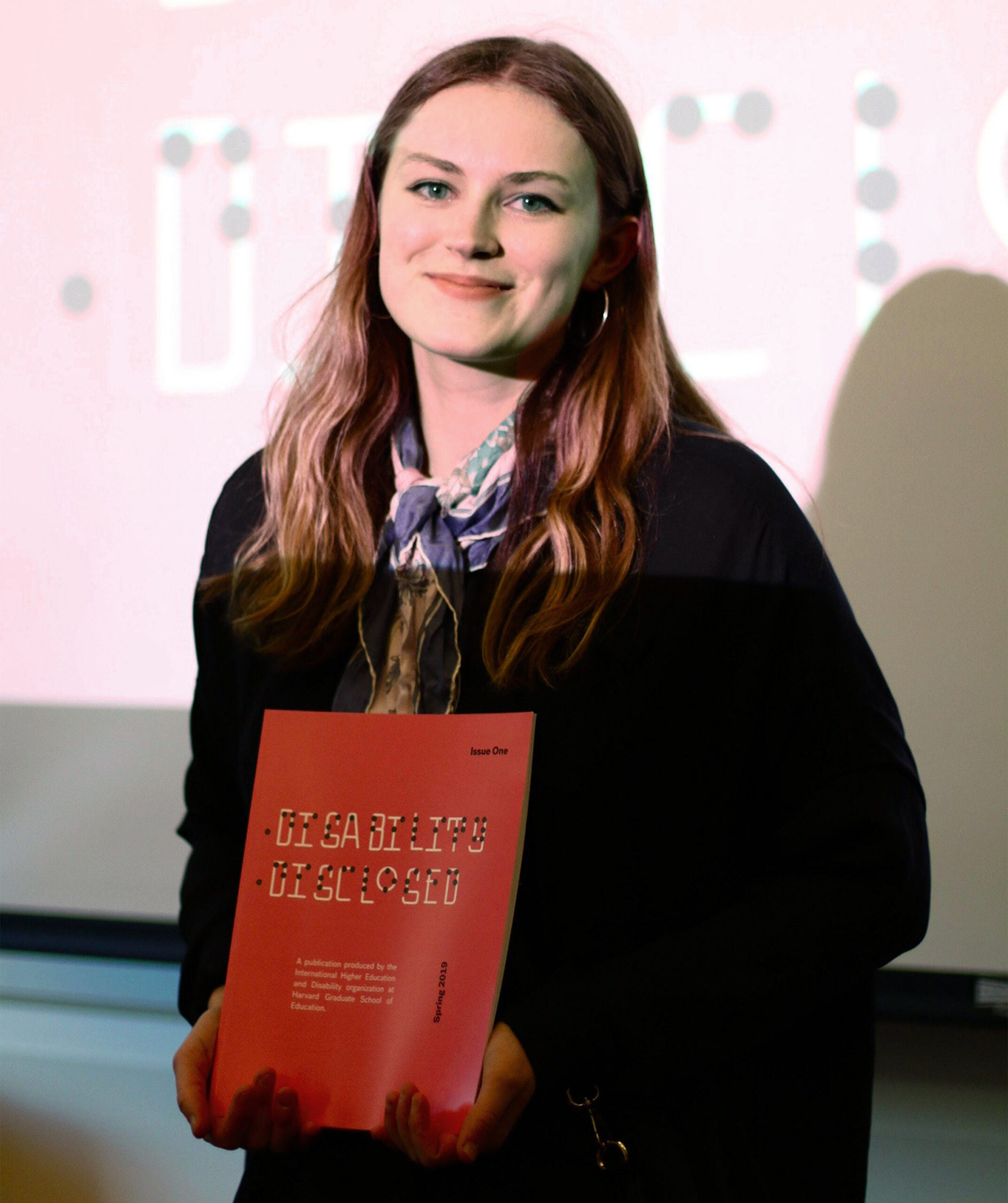 Nikita Andersson holding a copy of the journal.