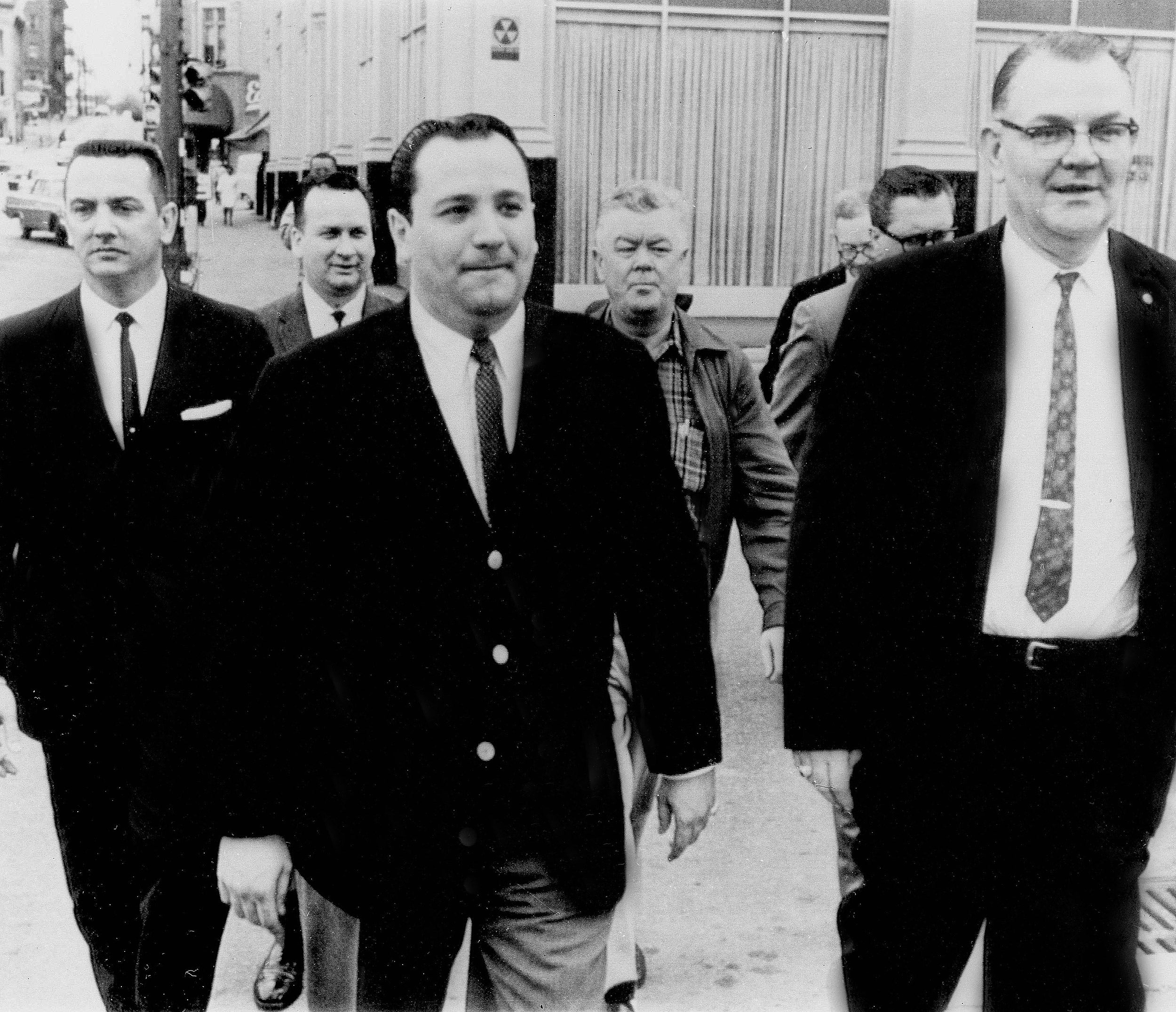 Charles L. O'Brien, center, is accompanied by U.S. marshals