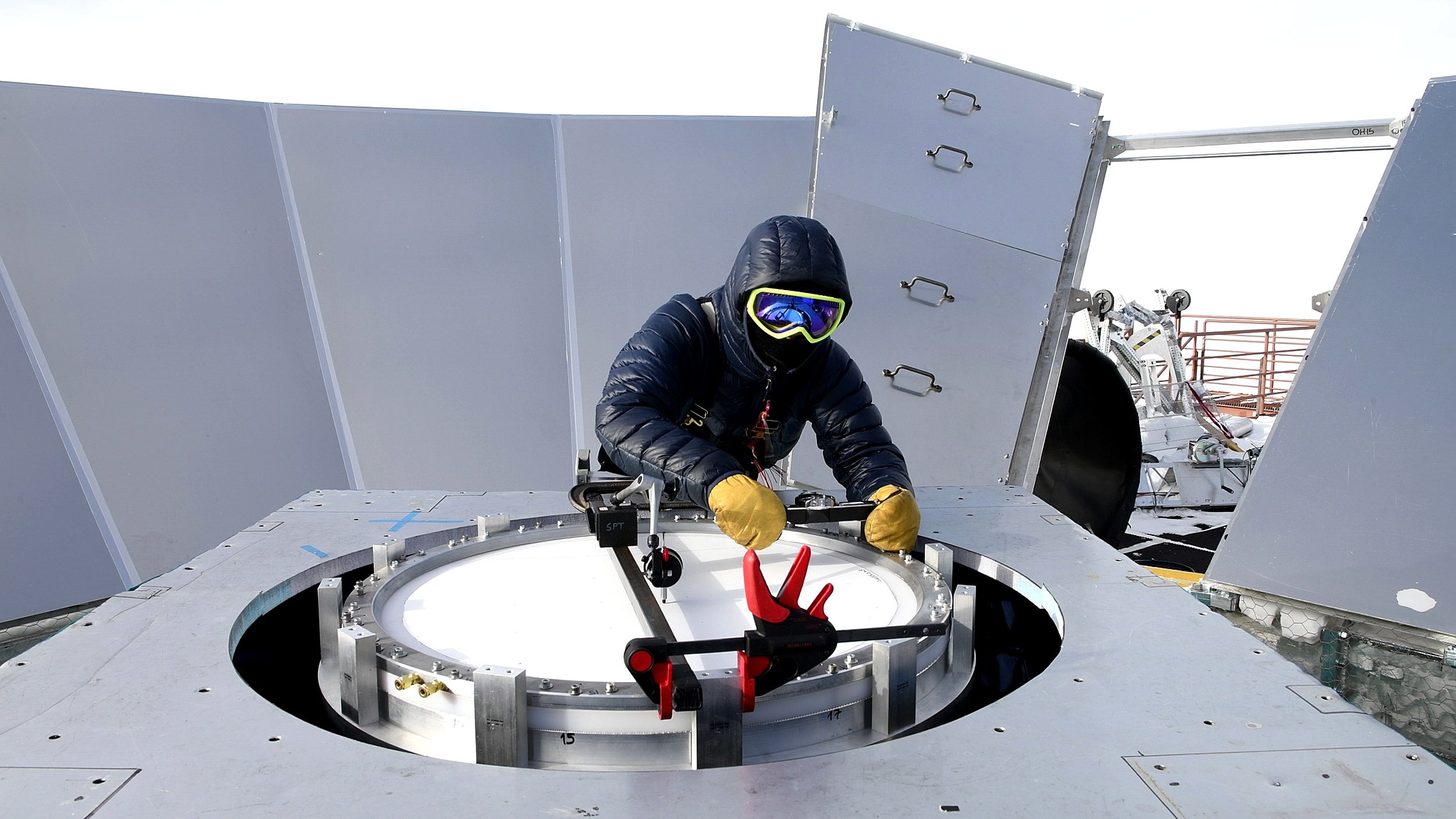 Installing a new vacuum window on the BICEP3 telescope.